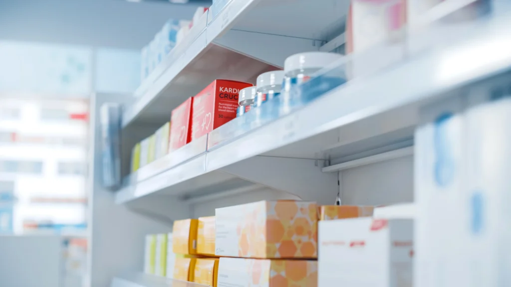 Pharmaceutical products on a retail pharmacy shelf, illustrating the importance of reliable cold chain precision logistics for advanced therapies to ensure medication availability and integrity at the point of care.